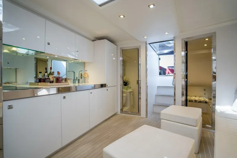 Slide: The Image of Luxurious interior of 2016 VanDutch 55 yacht with modern white cabinetry and seating. - 13