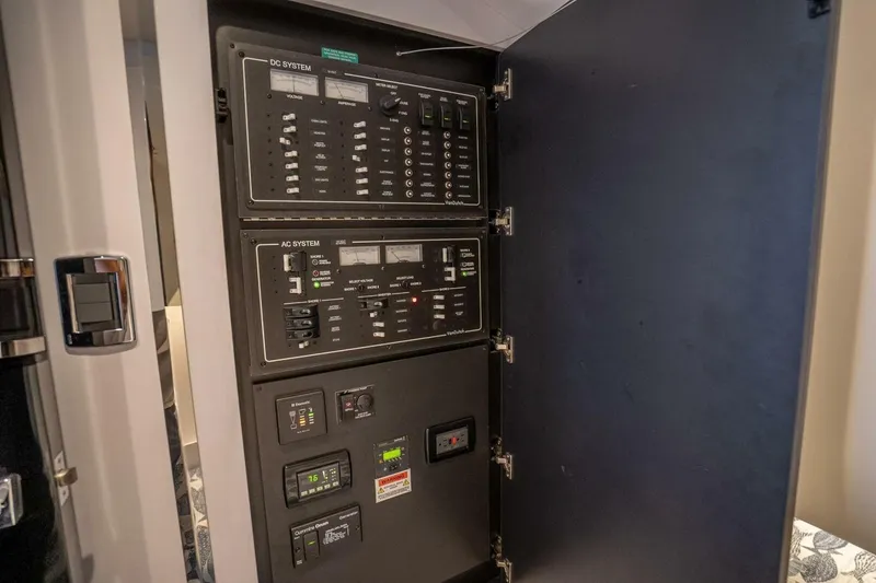 Slide: The Image of Electrical control panel inside a 2016 VanDutch 55 yacht, featuring AC and DC systems. - 20