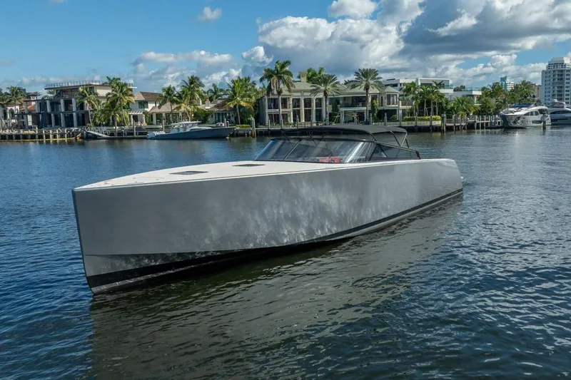 Slide: The Image of Luxurious 2016 VanDutch 55 yacht cruising on a scenic waterfront with palm trees. - 3