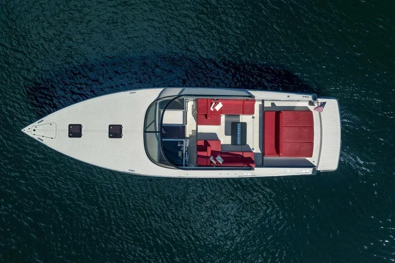 Slide: The Image of Aerial view of 2016 VanDutch 55 yacht with red seating on blue water. - 5