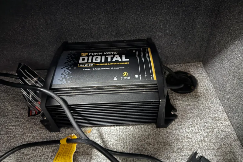 Slide: The Image of Minn Kota MK 210D on-board battery charger in 2023 Alumacraft Competitor 185 Tiller boat. - 12