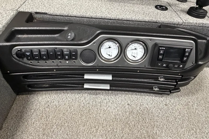 Slide: The Image of 2023 Alumacraft Competitor 185 Tiller dashboard with gauges and control panel. - 16