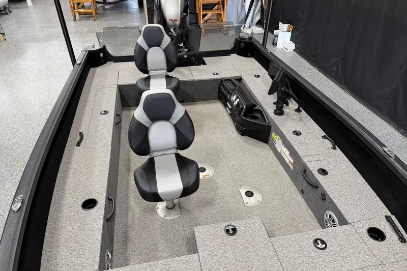 Slide: The Image of 2023 Alumacraft Competitor 185 Tiller boat interior with seating and control panel. - 7