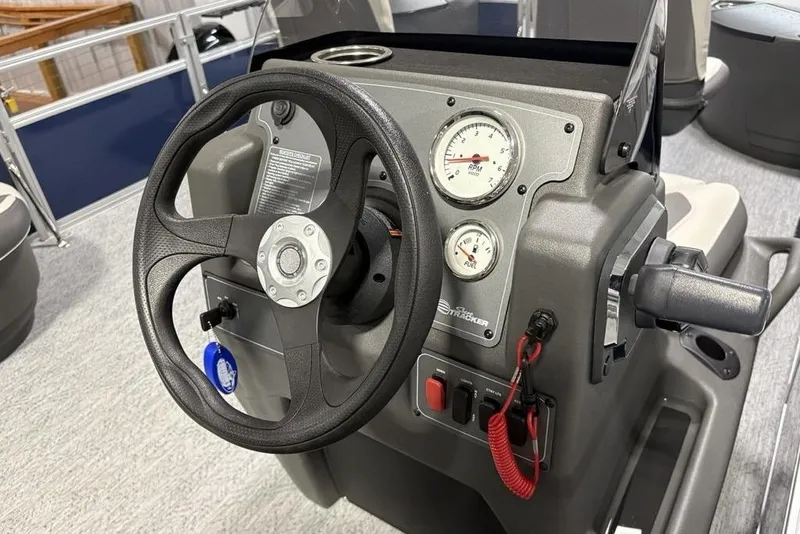 Slide: The Image of 2026 Sun Tracker BASS BUGGY® 18 DLX steering console with gauges and controls. - 16