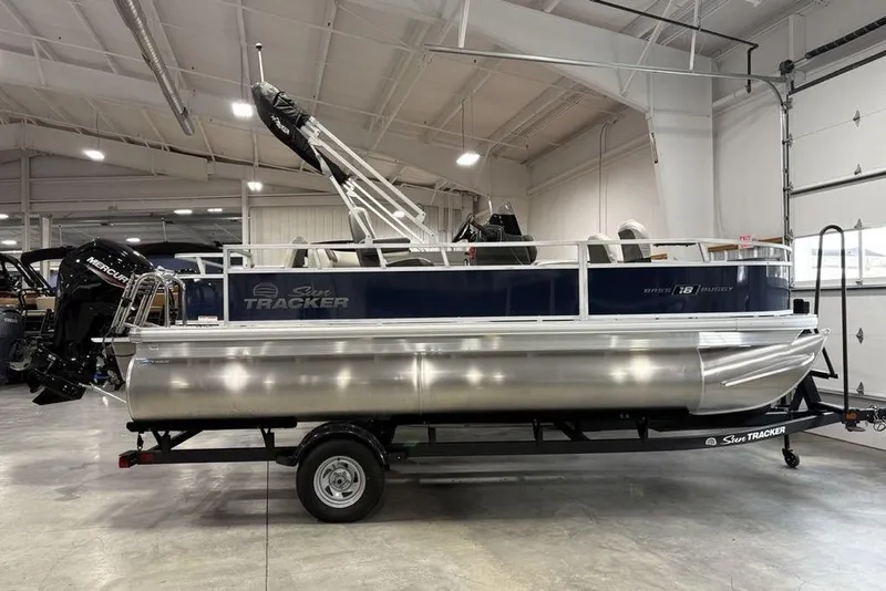The Image of 2026 Sun Tracker BASS BUGGY® 18 DLX pontoon boat in a showroom setting. - 2