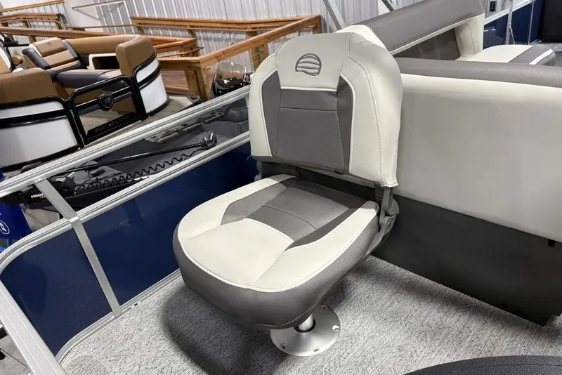 Slide: The Image of 2026 Sun Tracker BASS BUGGY® 18 DLX boat seat, gray and white upholstery, indoor display. - 22