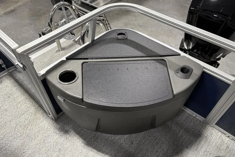 Slide: The Image of 2026 Sun Tracker BASS BUGGY® 18 DLX boat interior with storage compartment and cup holders. - 26