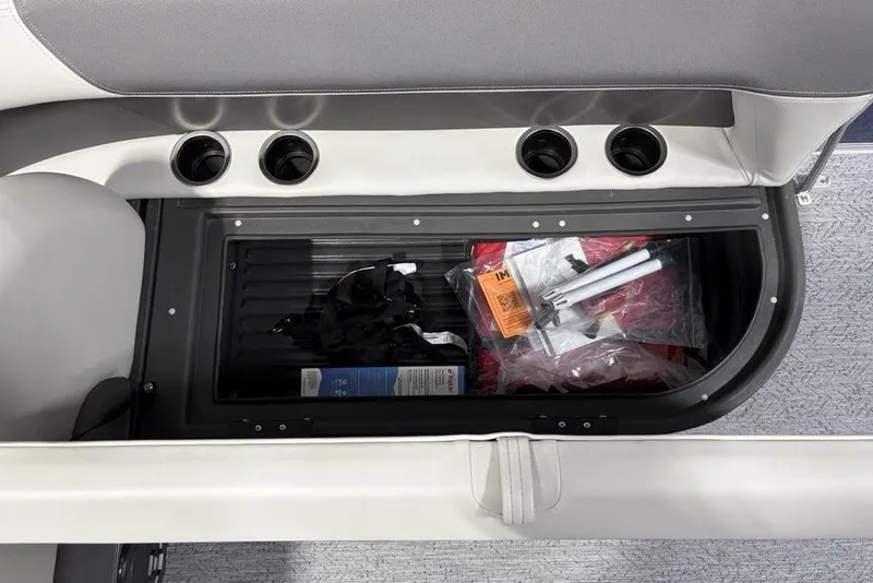 Slide: The Image of 2026 Sun Tracker BASS BUGGY® 18 DLX storage compartment with various boating accessories. - 27