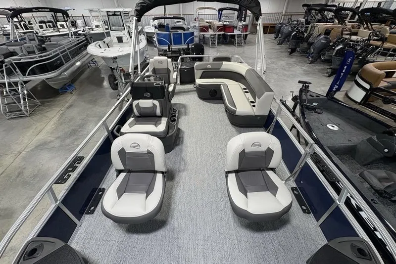 Slide: The Image of 2026 Sun Tracker BASS BUGGY® 18 DLX pontoon boat interior with seating, displayed in showroom. - 28