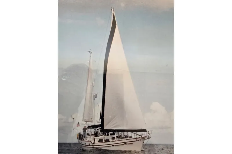 The Image of 1982 Irwin 52 sailboat with full sails on open water. - 0