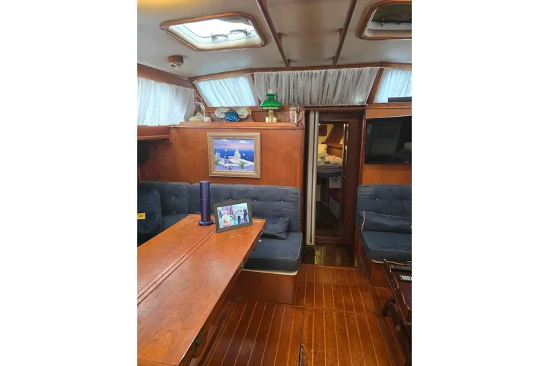 Slide: The Image of Interior of 1982 Irwin 52 sailboat with wooden furnishings and cozy seating area. - 11