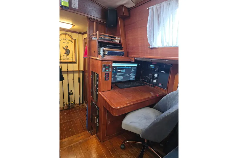 Slide: The Image of Navigation station inside 1982 Irwin 52 sailboat with wooden desk and electronics. - 15
