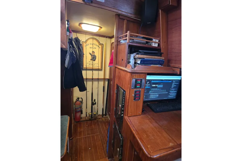 Slide: The Image of Interior of 1982 Irwin 52 sailboat with fishing rods and navigation equipment. - 16