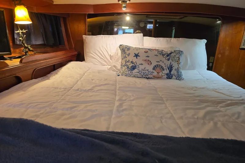 Slide: The Image of Cozy cabin bedroom in 1982 Irwin 52 yacht with nautical-themed decor. - 18