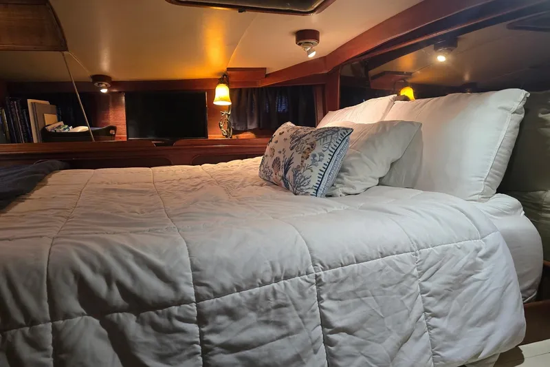 Slide: The Image of Cozy bedroom in 1982 Irwin 52 yacht with plush bedding and warm lighting. - 19