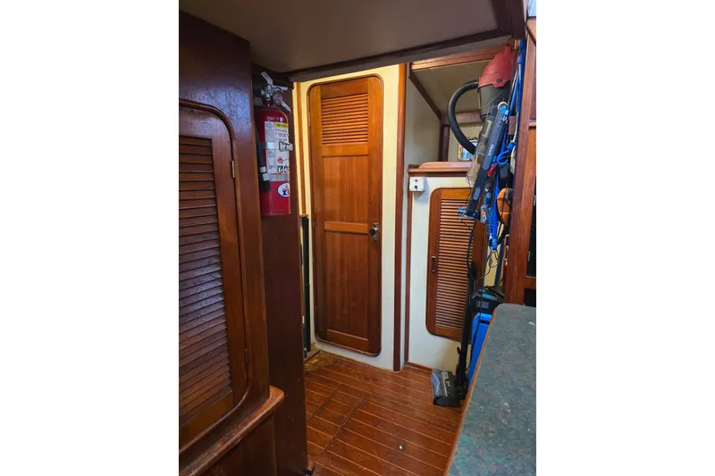Slide: The Image of Interior of 1982 Irwin 52 sailboat with wooden doors and fire extinguisher. - 21