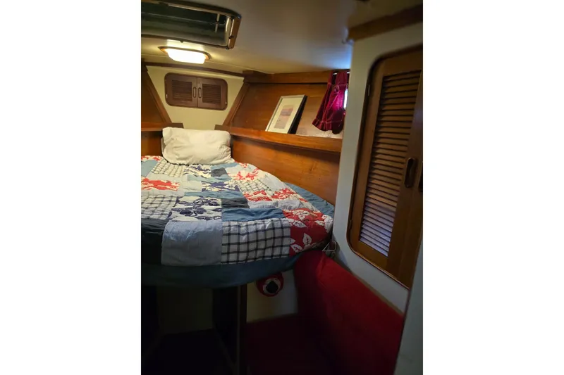 Slide: The Image of Cozy cabin interior of 1982 Irwin 52 sailboat with colorful bedding and wooden accents. - 26