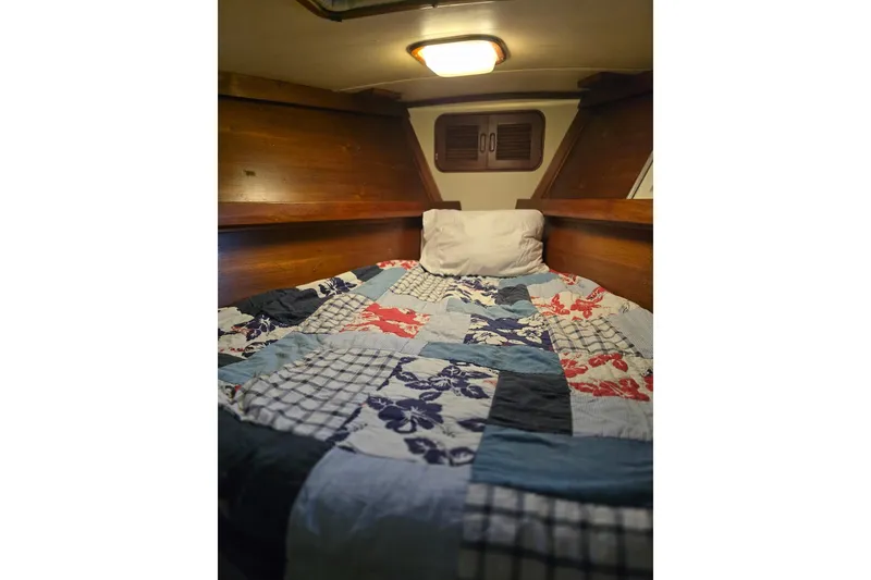 Slide: The Image of Cozy cabin bed with colorful quilt in 1982 Irwin 52 sailboat. - 27