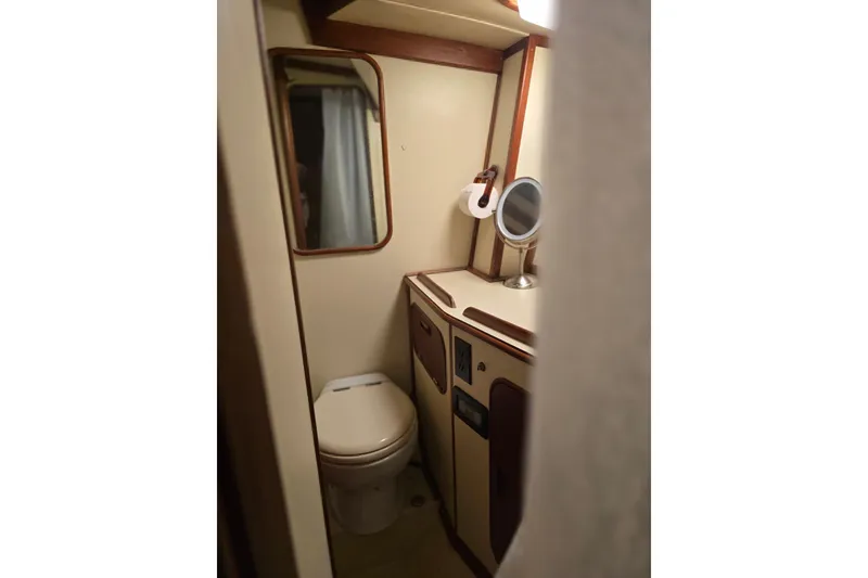 Slide: The Image of 1982 Irwin 52 yacht bathroom with toilet, mirror, and compact design. - 29