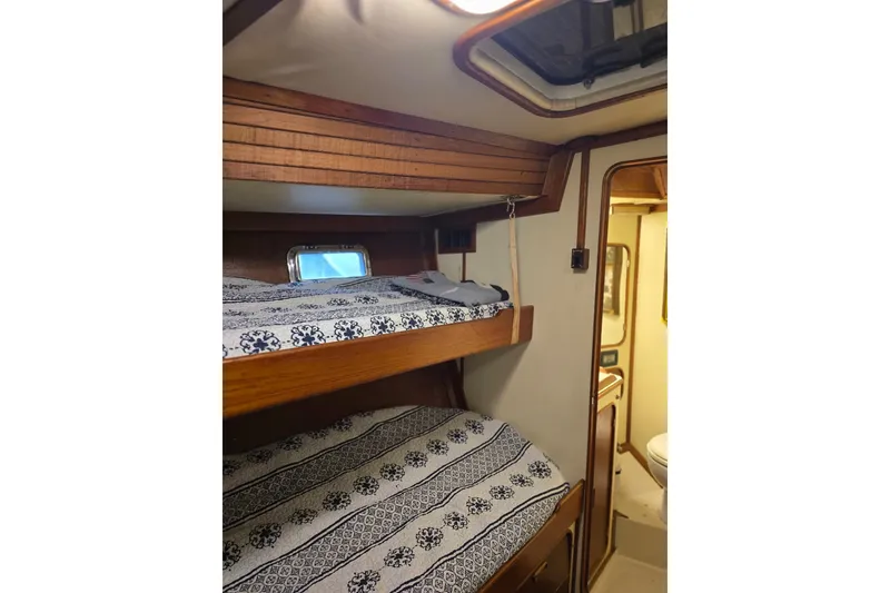 Slide: The Image of Interior of 1982 Irwin 52 sailboat with cozy bunk beds and nautical decor. - 30