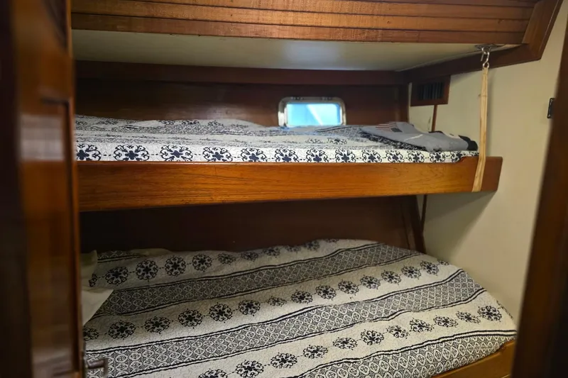 Slide: The Image of Cozy bunk beds in 1982 Irwin 52 sailboat cabin with patterned bedding. - 31