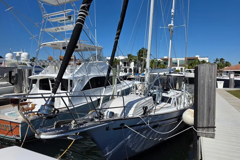 Slide: The Image of 1982 Irwin 52 sailboat docked at marina with clear blue sky. - 5