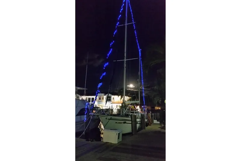 Slide: The Image of 1982 Irwin 52 sailboat with blue lights docked at night. - 7