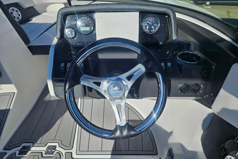 Slide: The Image of Steering wheel of 2022 Monterey M-225 boat with dashboard controls. - 16
