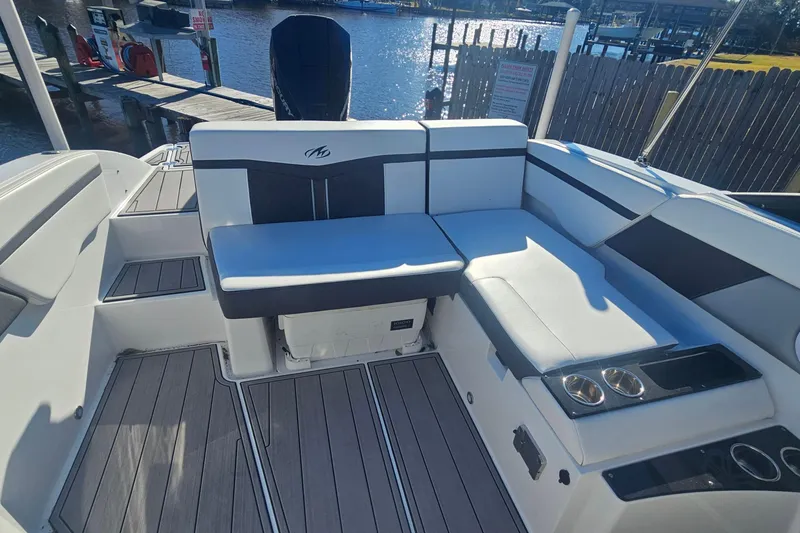 Slide: The Image of 2022 Monterey M-225 boat interior with sleek seating and cup holders. - 17