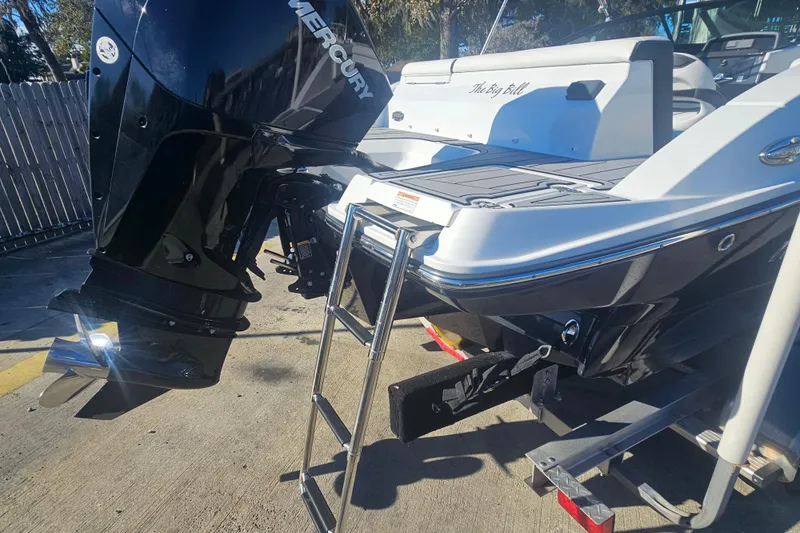 Slide: The Image of 2022 Monterey M-225 boat with Mercury engine and swim ladder, parked on trailer. - 4