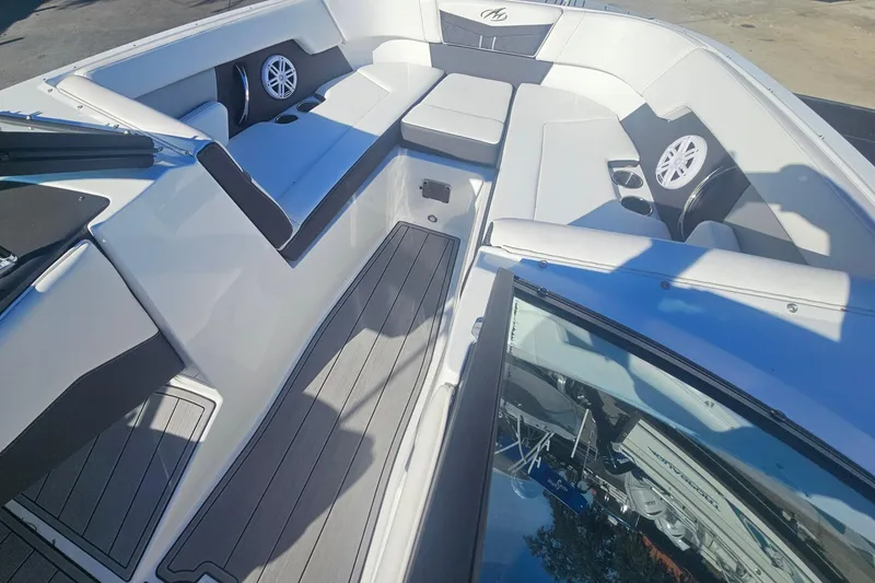 Slide: The Image of 2022 Monterey M-225 boat interior with cushioned seating and speakers. - 7
