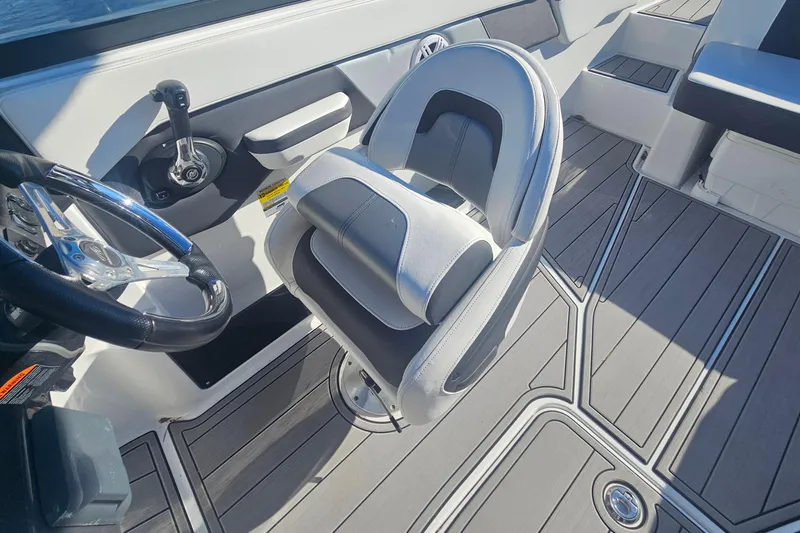 Slide: The Image of 2022 Monterey M-225 boat interior with steering wheel and modern seating. - 8