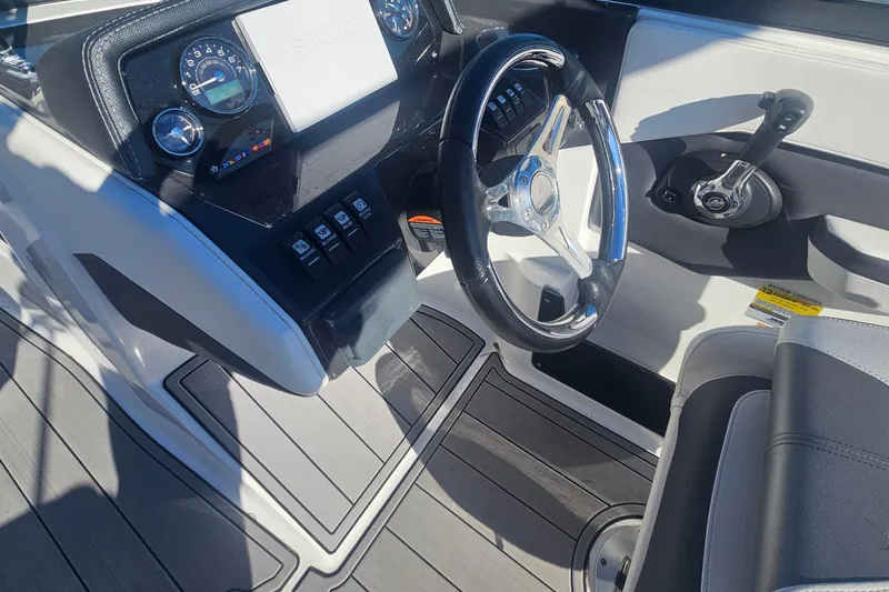 Slide: The Image of 2022 Monterey M-225 boat dashboard with steering wheel and control panel. - 9