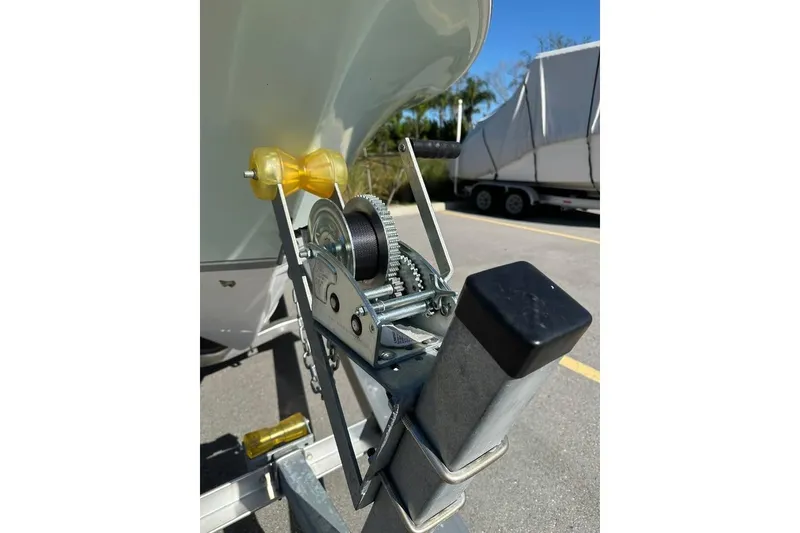 Slide: The Image of 2016 Sea Hunt Ultra 211 boat on trailer in suburban driveway, clear sky background. - 10