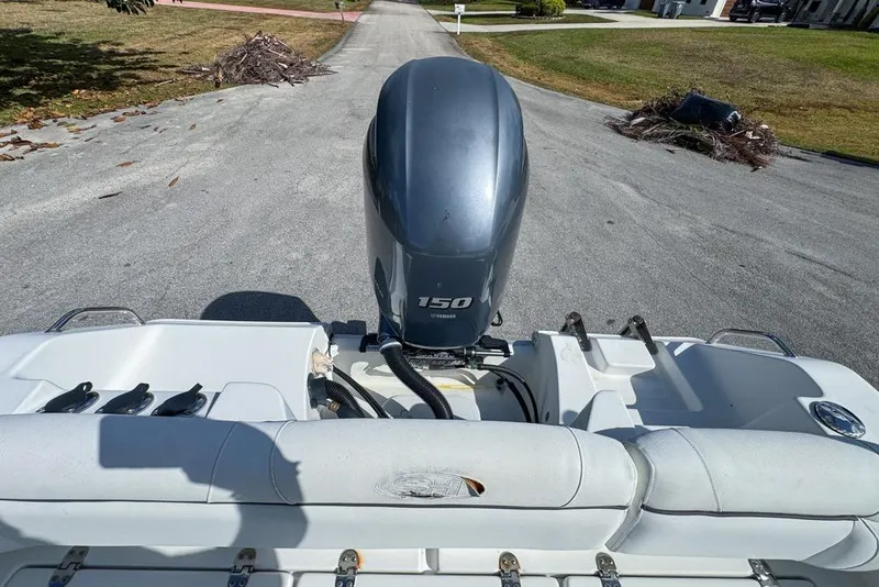 Slide: The Image of 2016 Sea Hunt Ultra 211 boat with Yamaha 150 outboard motor on a road. - 101