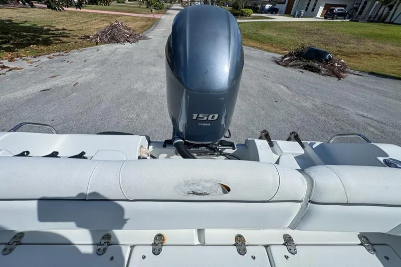 Slide: The Image of 2016 Sea Hunt Ultra 211 boat with Yamaha 150 engine, parked on a driveway. - 102