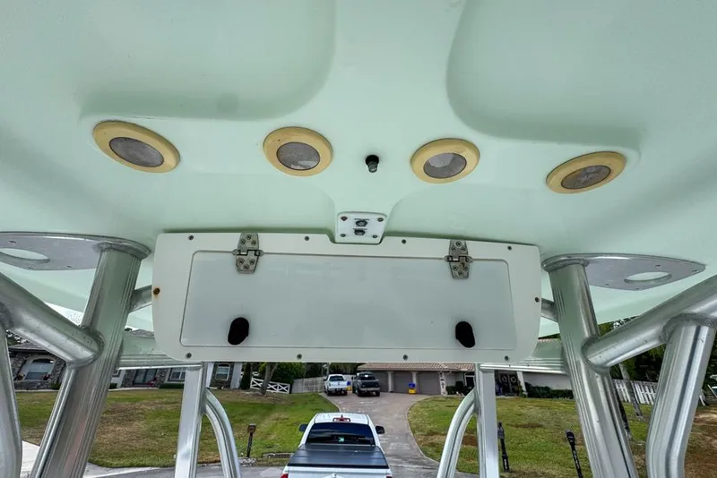 Slide: The Image of 2016 Sea Hunt Ultra 211 boat interior with speakers and storage compartment. - 107