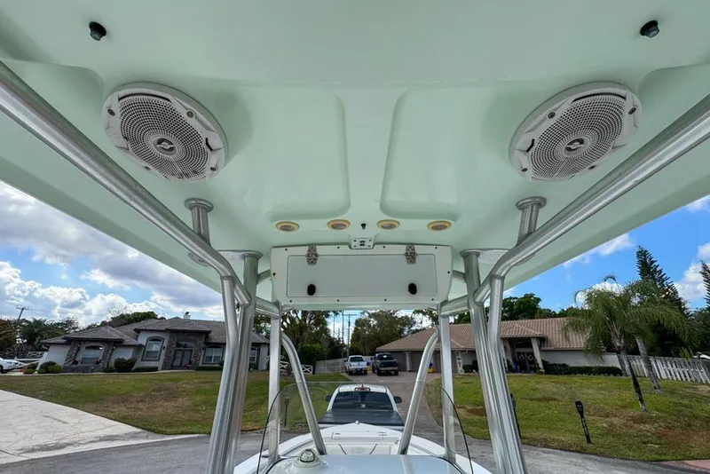 Slide: The Image of 2016 Sea Hunt Ultra 211 boat T-top with speakers and support poles. - 109