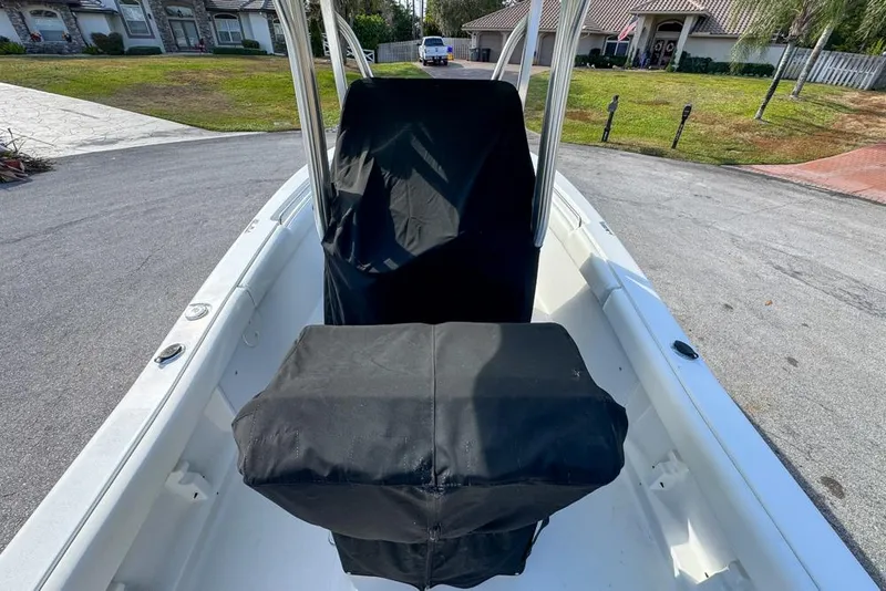 Slide: The Image of 2016 Sea Hunt Ultra 211 boat interior with covered console and seating. - 115