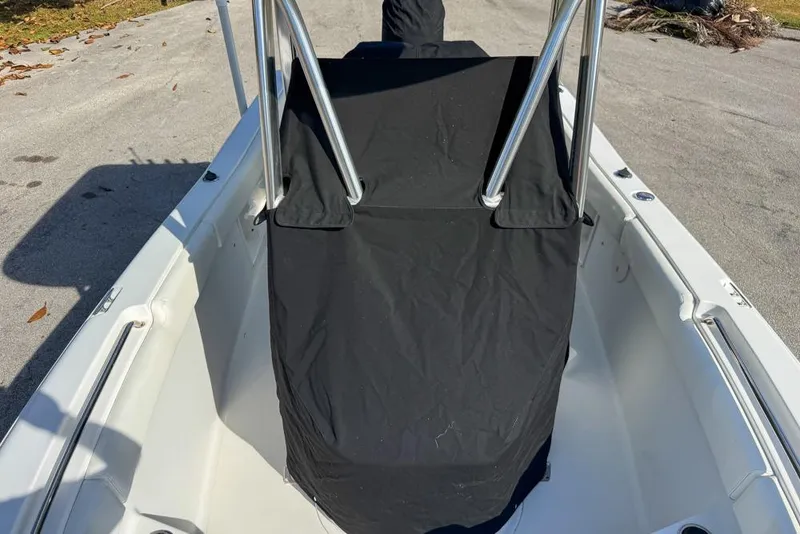 Slide: The Image of 2016 Sea Hunt Ultra 211 boat with black console cover on a sunny day. - 116