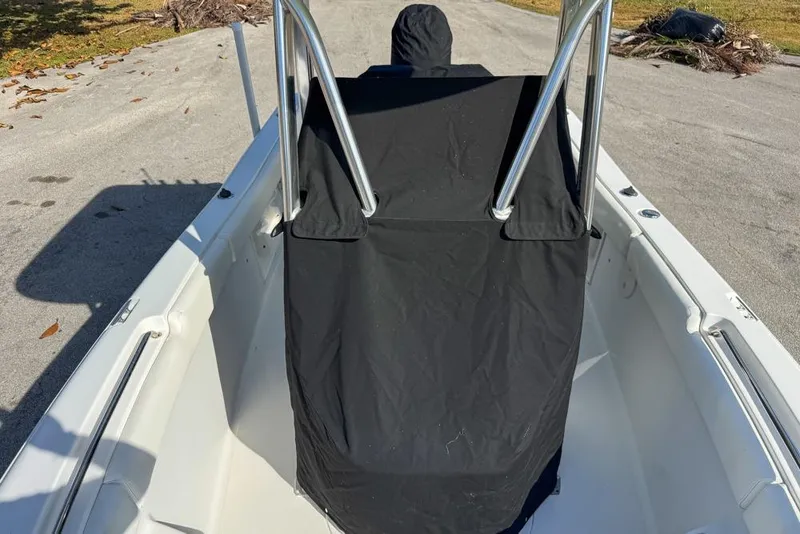 Slide: The Image of 2016 Sea Hunt Ultra 211 boat with covered console on a sunny day. - 117