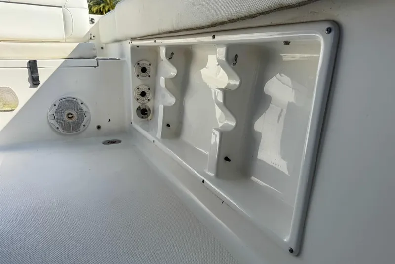 Slide: The Image of Interior view of a 2016 Sea Hunt Ultra 211 boat, featuring rod holders and speaker. - 119