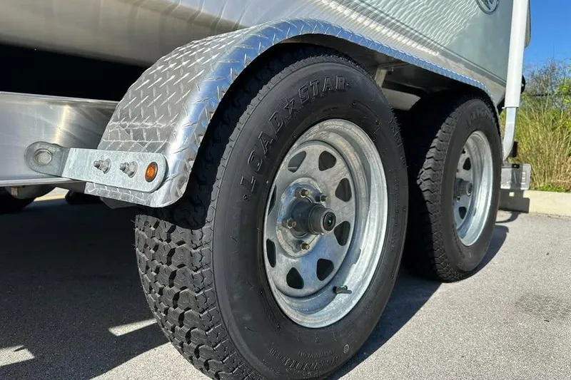 Slide: The Image of 2016 Sea Hunt Ultra 211 boat on trailer, parked in driveway. - 13