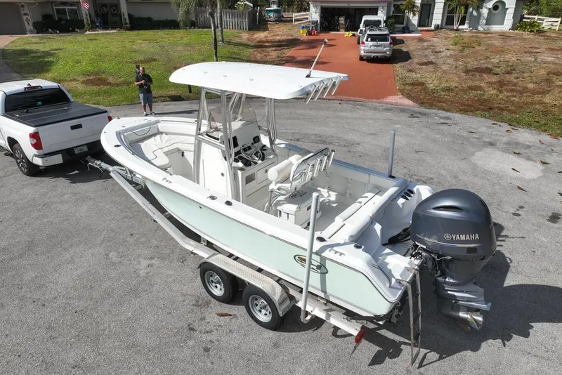 Slide: The Image of 2016 Sea Hunt Ultra 211 boat on trailer, attached to a white pickup truck. - 14