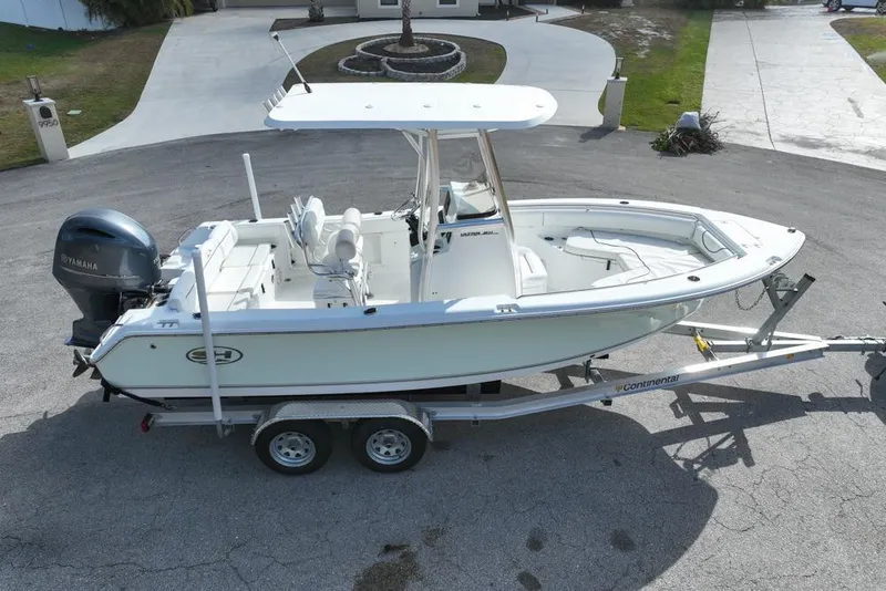 Slide: The Image of 2016 Sea Hunt Ultra 211 boat on trailer, parked in driveway. - 17