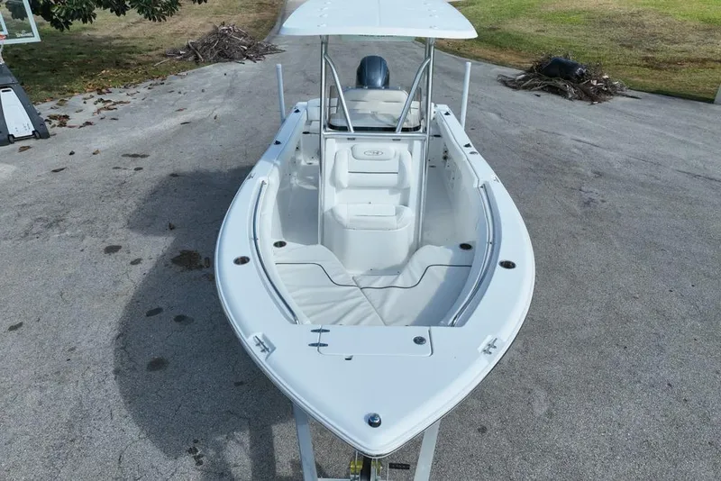 Slide: The Image of 2016 Sea Hunt Ultra 211 boat, white exterior, parked on concrete surface. - 19