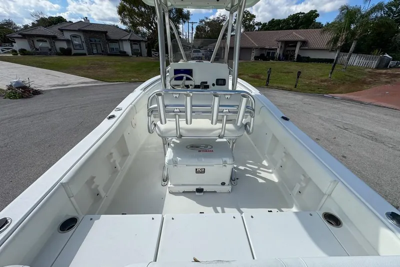 Slide: The Image of 2016 Sea Hunt Ultra 211 boat interior with seating and console, parked in residential area. - 22