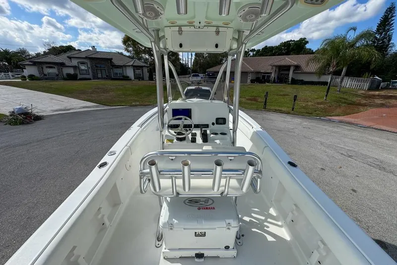 Slide: The Image of 2016 Sea Hunt Ultra 211 boat interior with console and seating, parked in residential area. - 25
