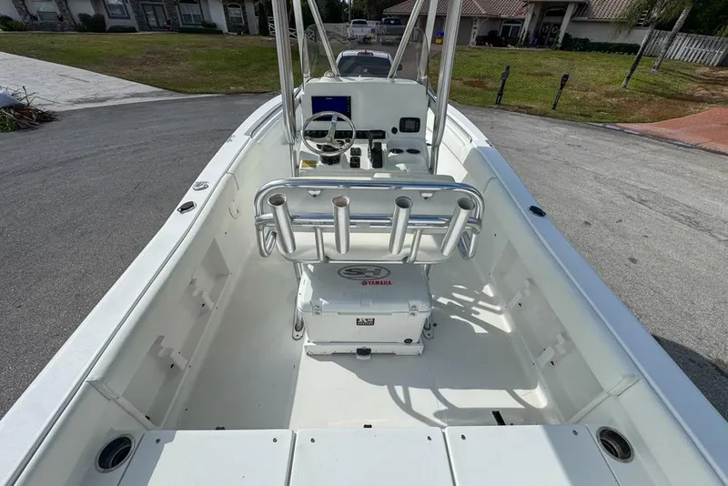 Slide: The Image of 2016 Sea Hunt Ultra 211 boat interior with steering console and rod holders. - 26