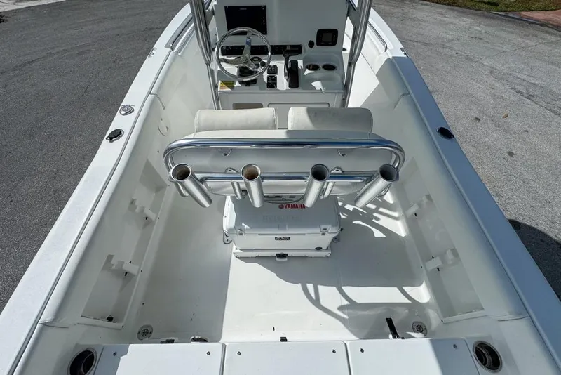 Slide: The Image of 2016 Sea Hunt Ultra 211 boat interior with steering console and rod holders. - 33